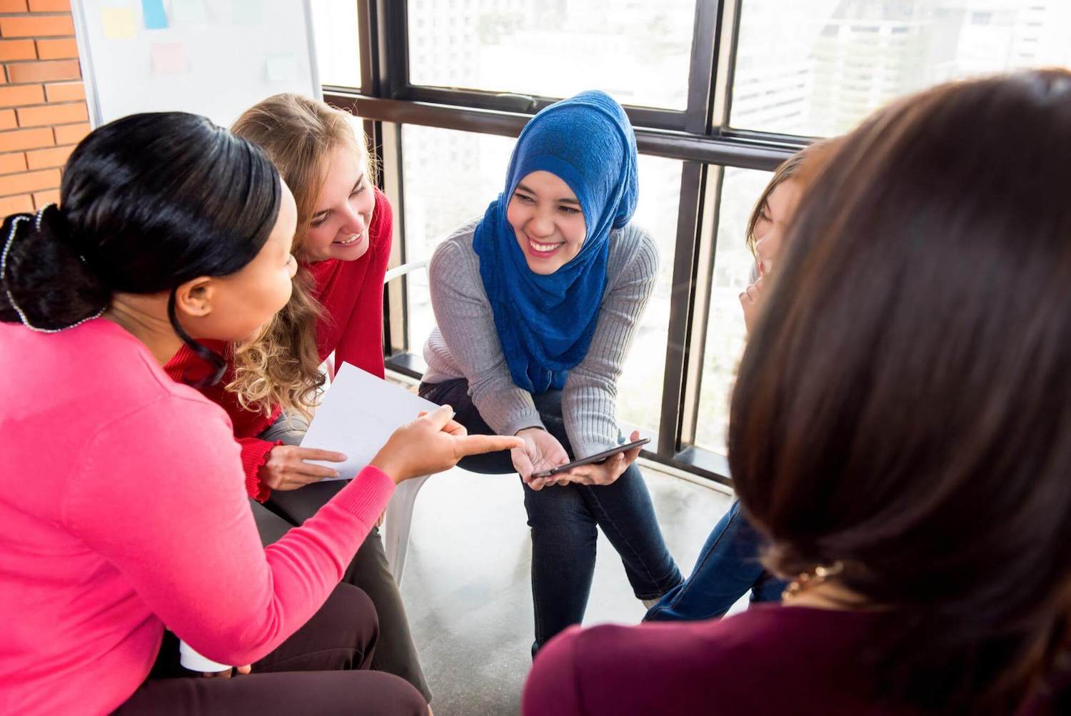 A group of women discussing giving Tuesday ideas