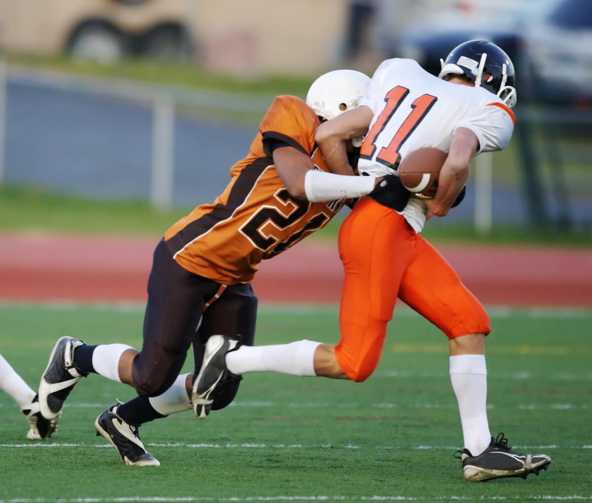 Football player tackling another player