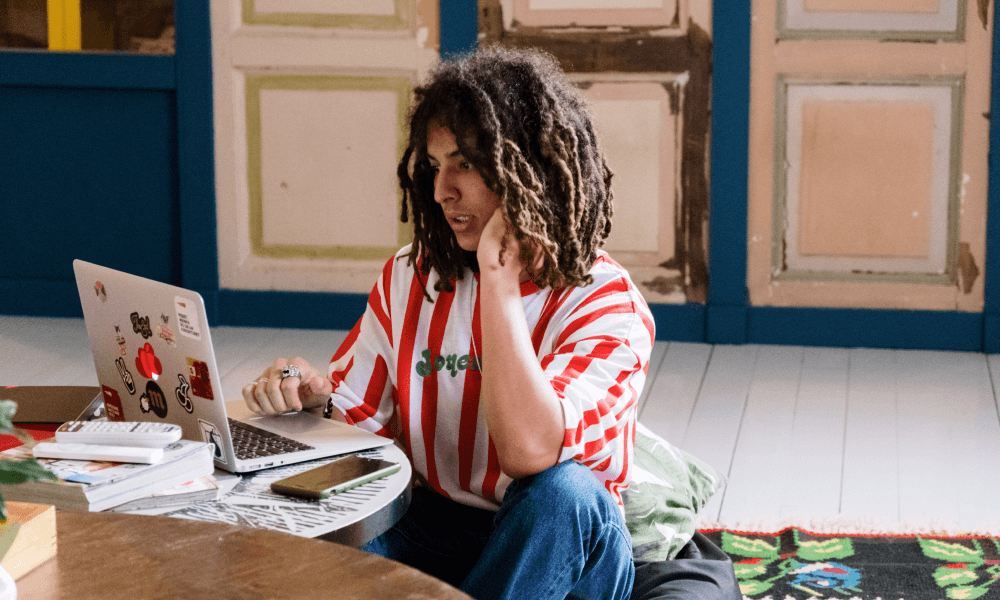 Man in striped shirt working on his laptop