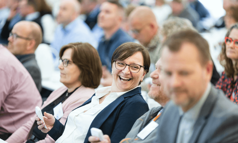 People laughing sitting on chairs