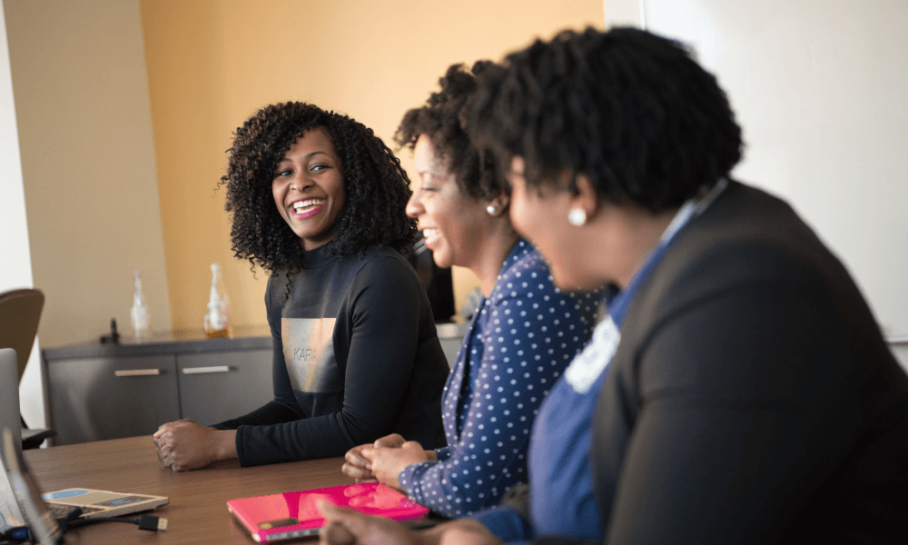 Three women sitting in a meeting room