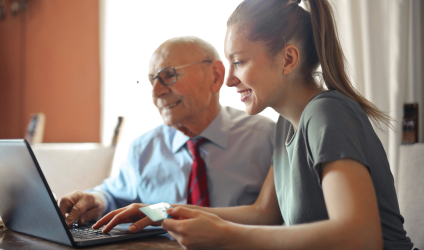 Young woman helping a senior board member with nonprofit finance