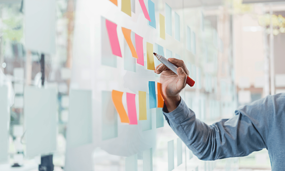 Man comparing fundraising platforms on several sticky notes